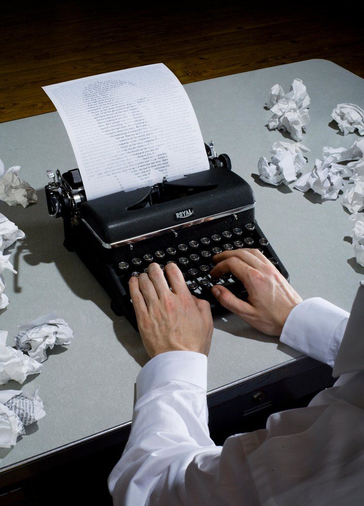 Hands writing on a vintage typewriter